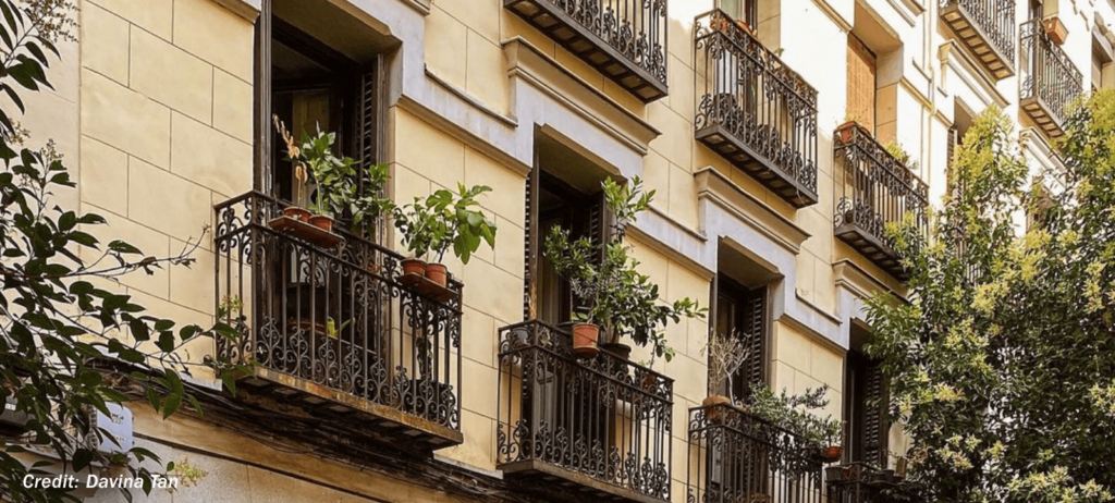 Ornate iron balconies on a building in the Malasaña neighborhood.
