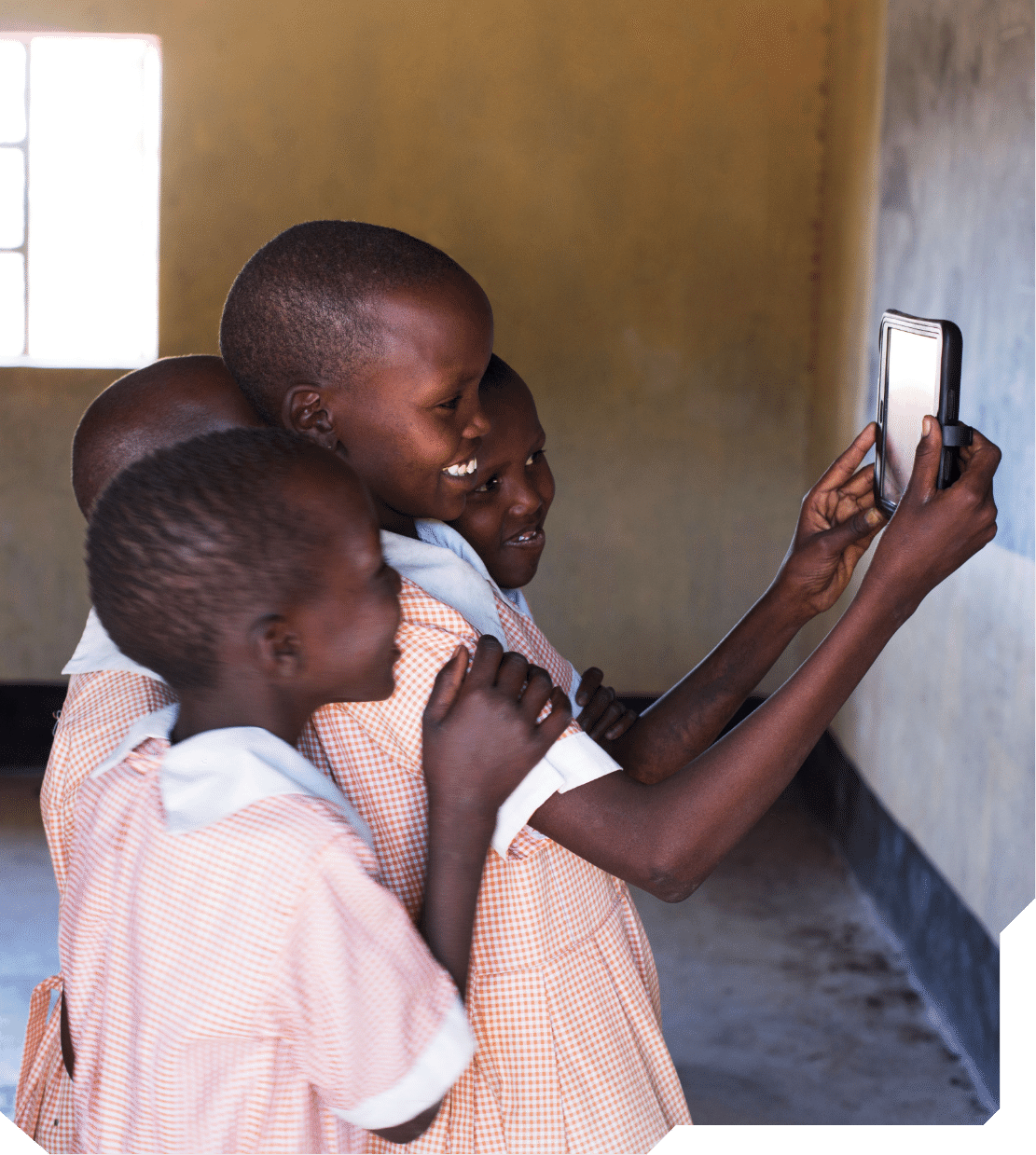 Children in an underserved school use a tablet for e-learning