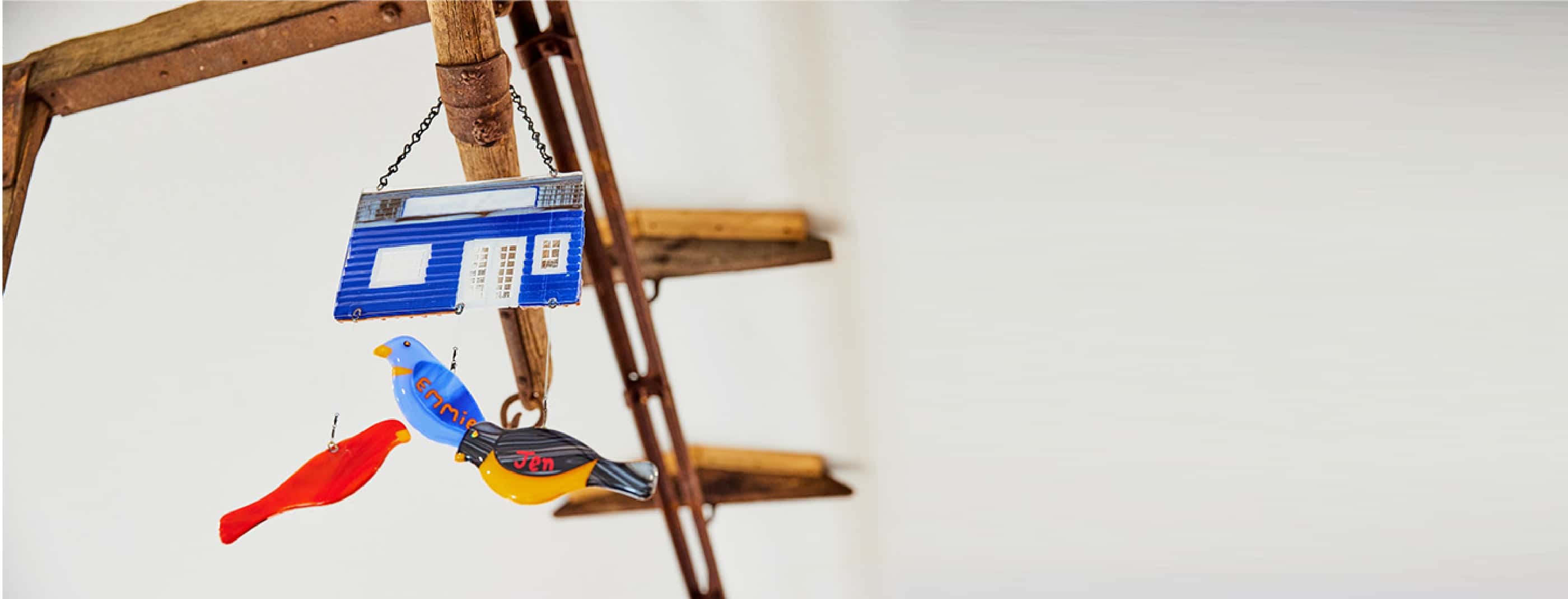 A handmade decoration in the café features three birds each painted with a name: Emmie, Jen and Rayna.