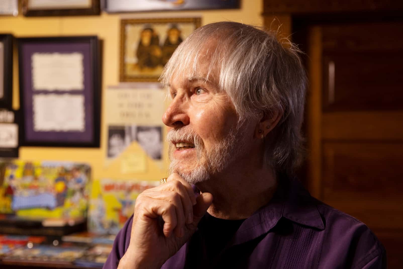 Zeek in his home studio, where the walls are covered with his art.