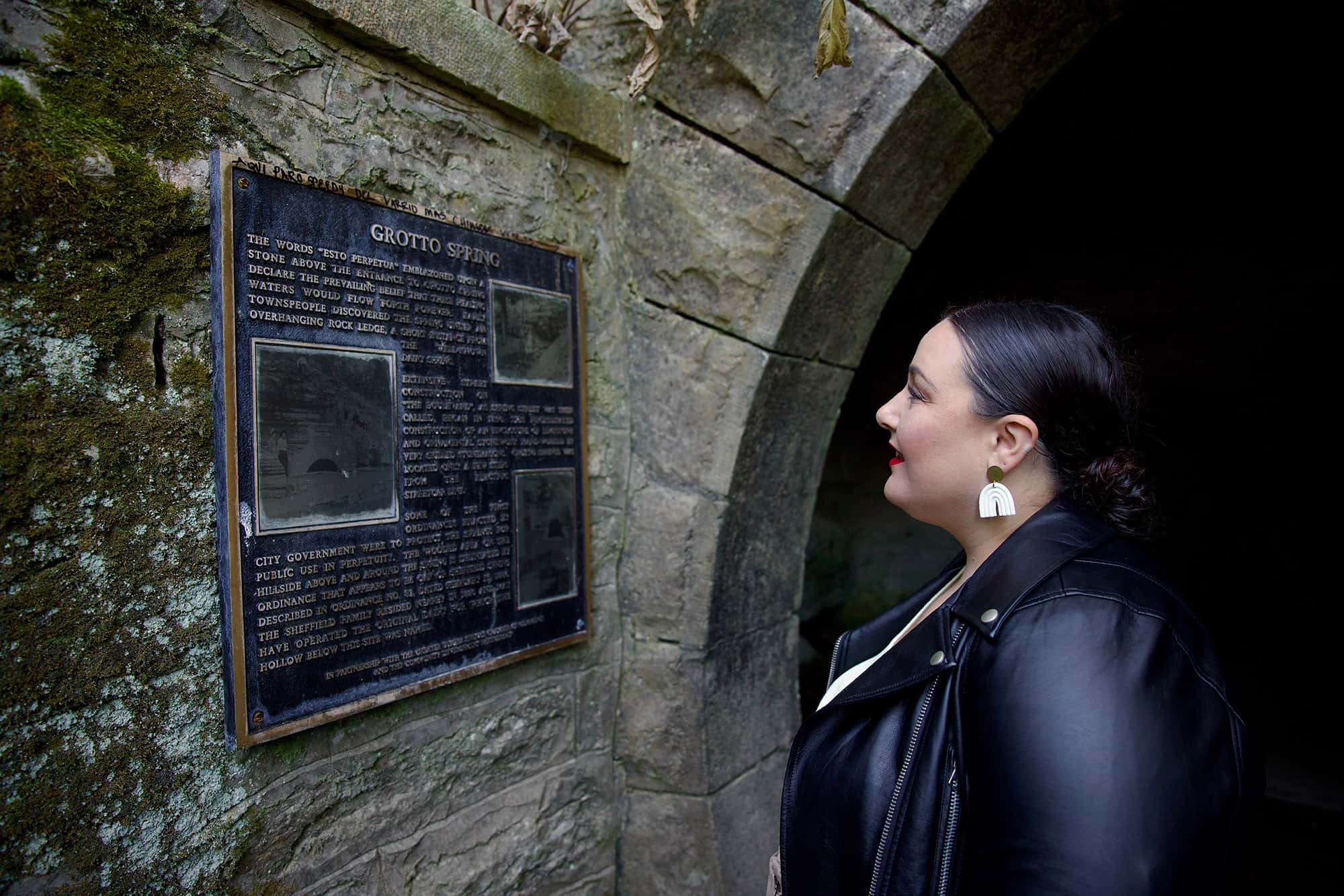Alysse reads the plaque outside the entrance to Grotto Spring, which is sequestered inside a limestone cavern.