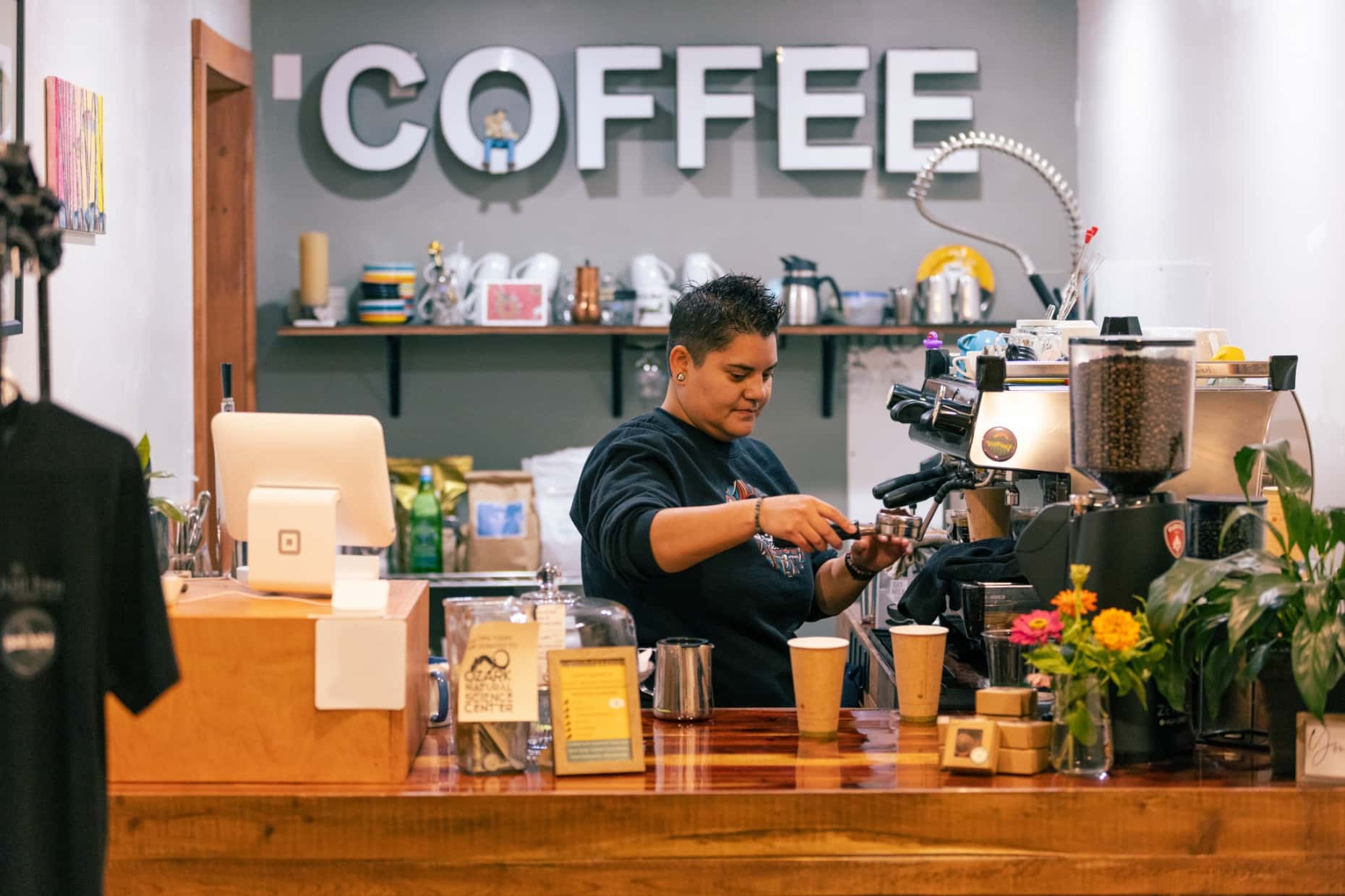 Belén makes a coffee at the espresso machine.
