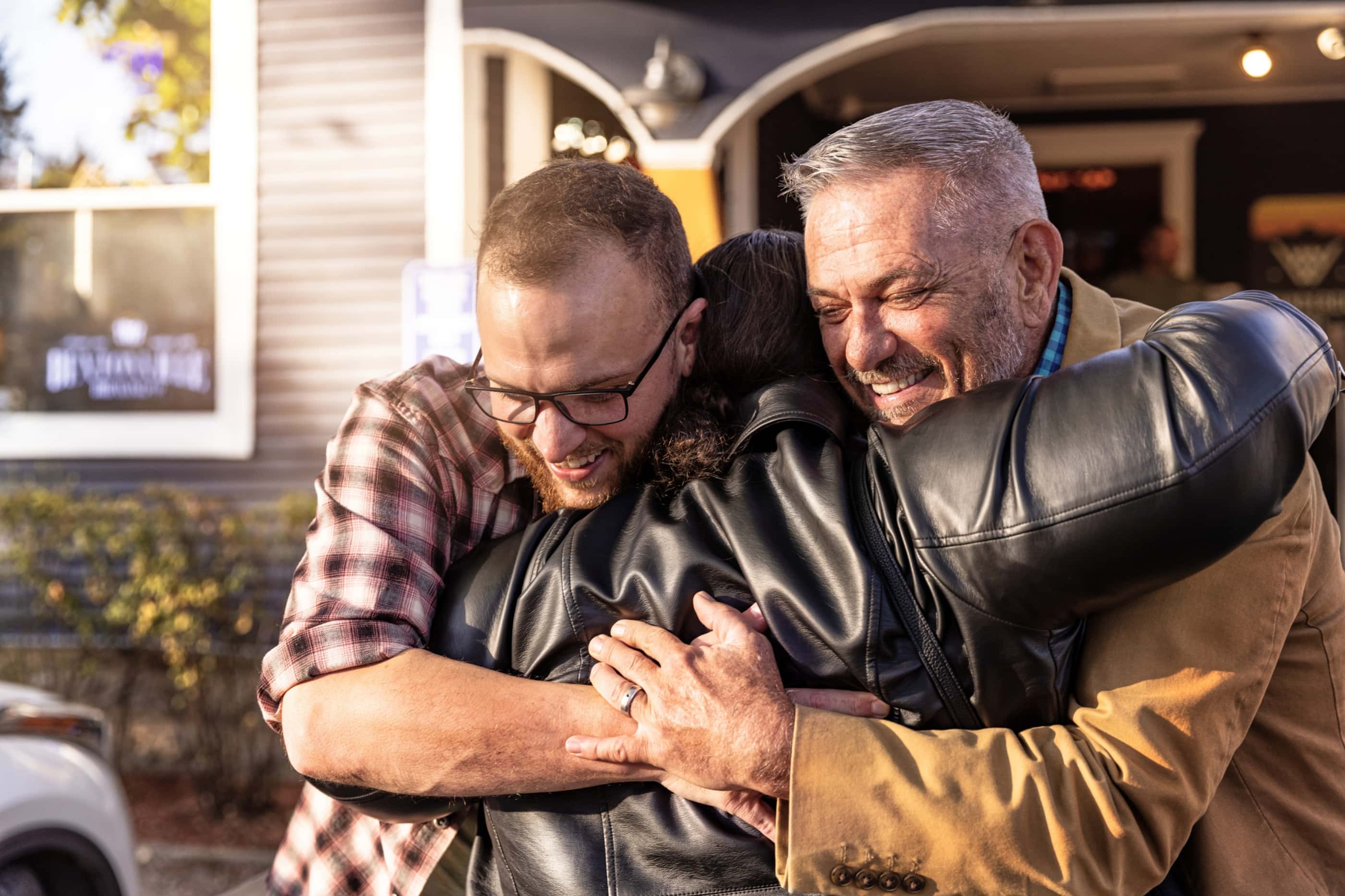 Ethan and David embrace Alysse in a heartfelt group hug.