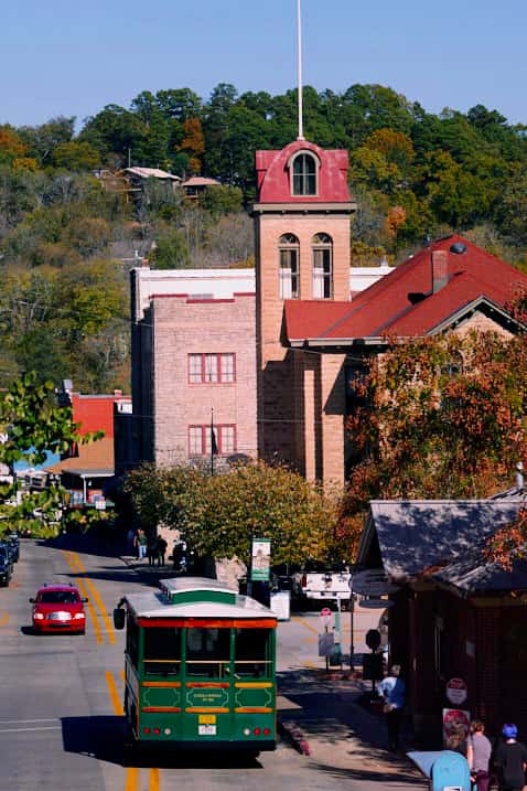The vintage-style Eureka Springs trolley bus drives through downtown.