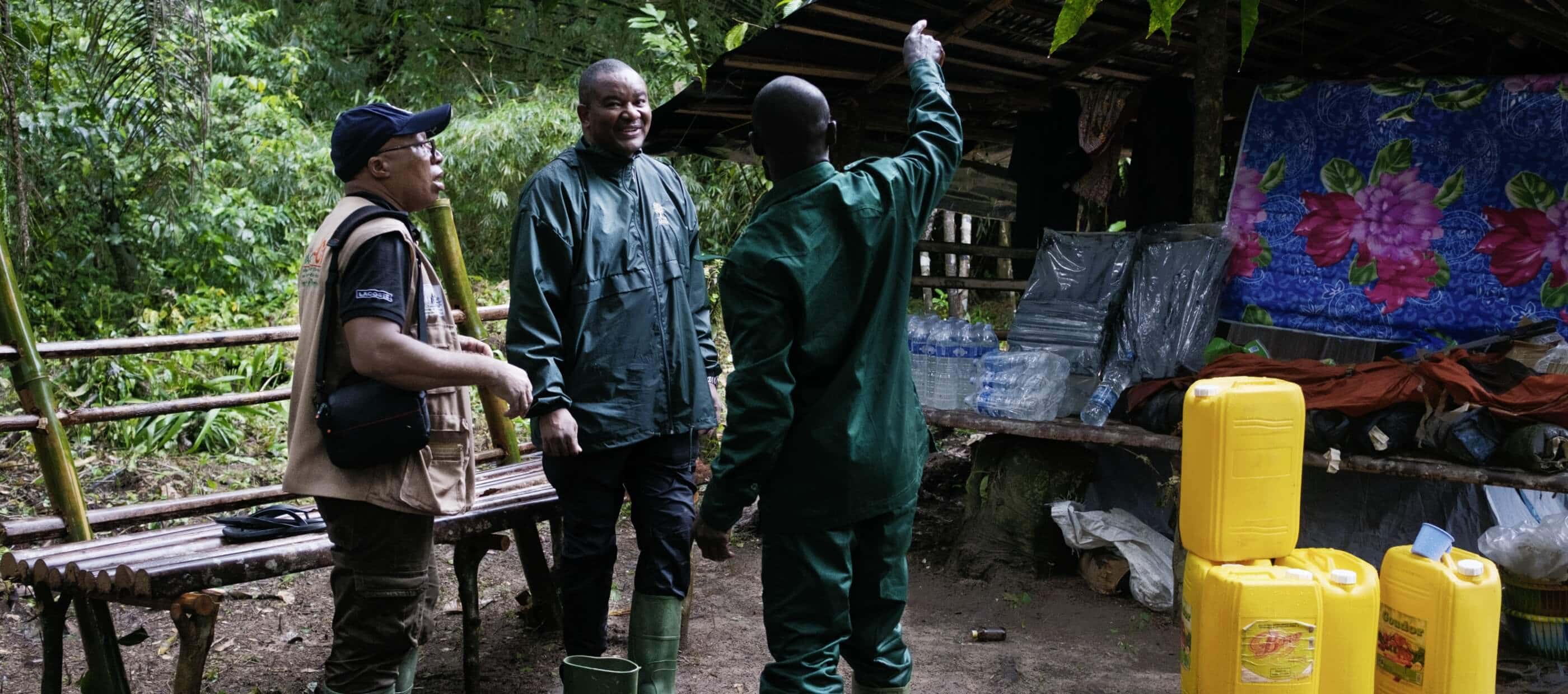 Primatologist Inza Koné confers with colleagues at camp.