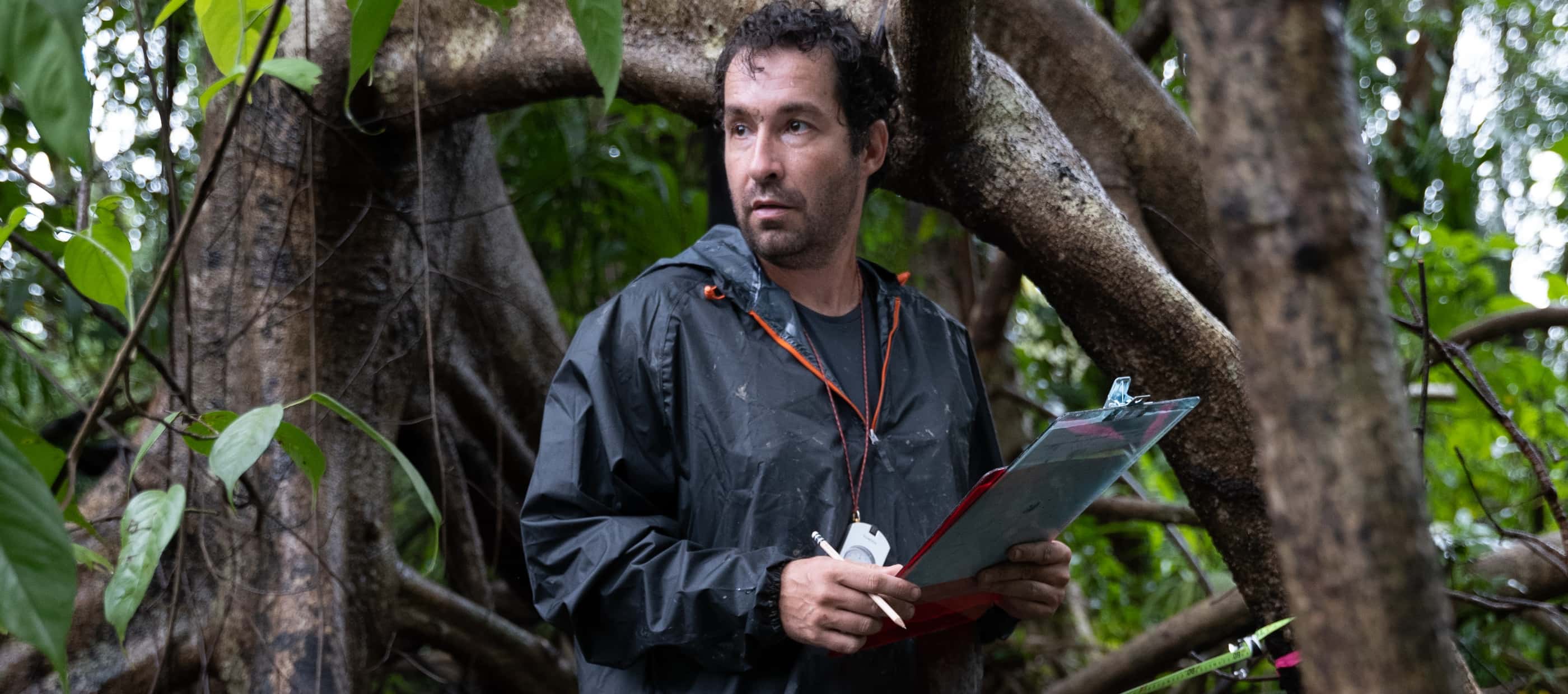 Angelo Bernardino, dressed in a waterproof jacket and holding a clipboard, collects data on the unusual freshwater mangrove forest.