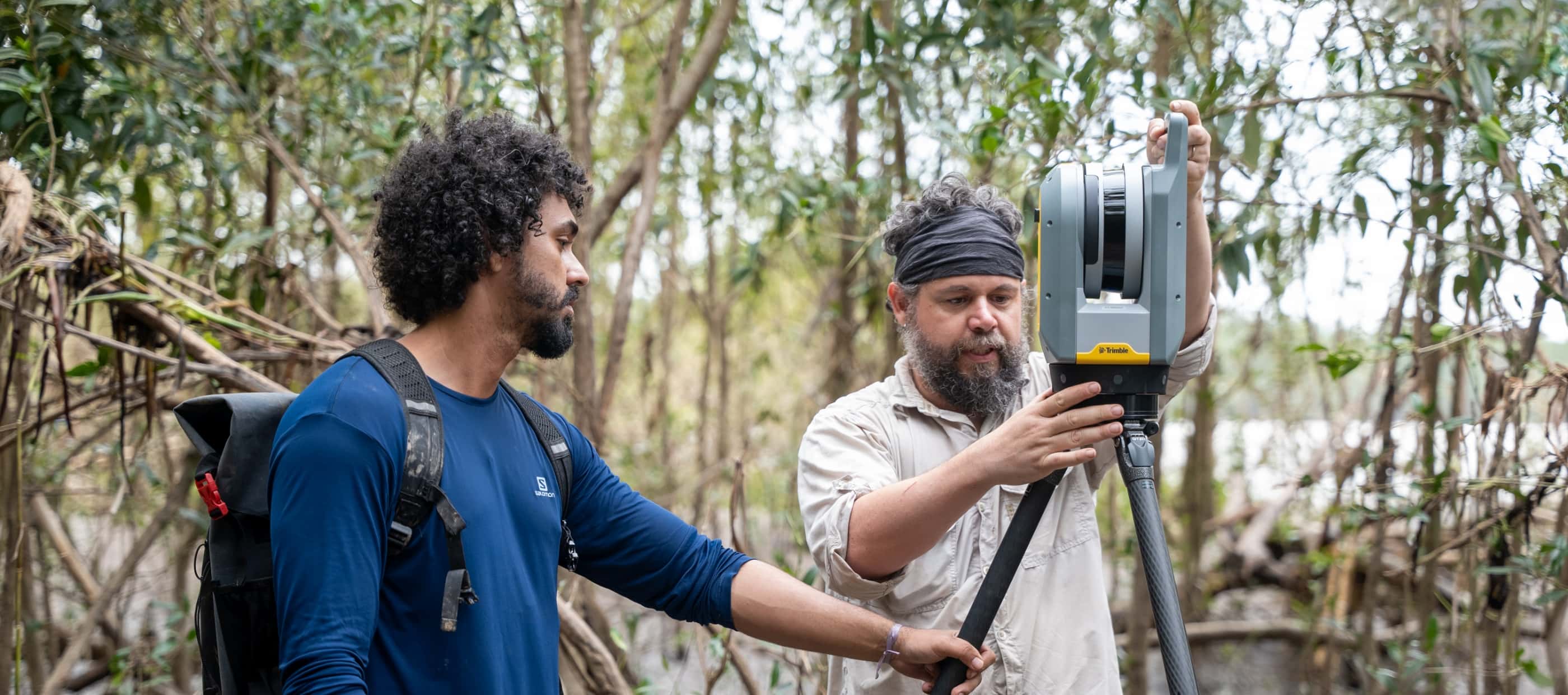 Thuareag Monteiro, a research team member, and National Geographic Explorer Thiago Silva work with a 3D laser scanner to produce a precise picture of the mangrove forest’s carbon storage capacity.