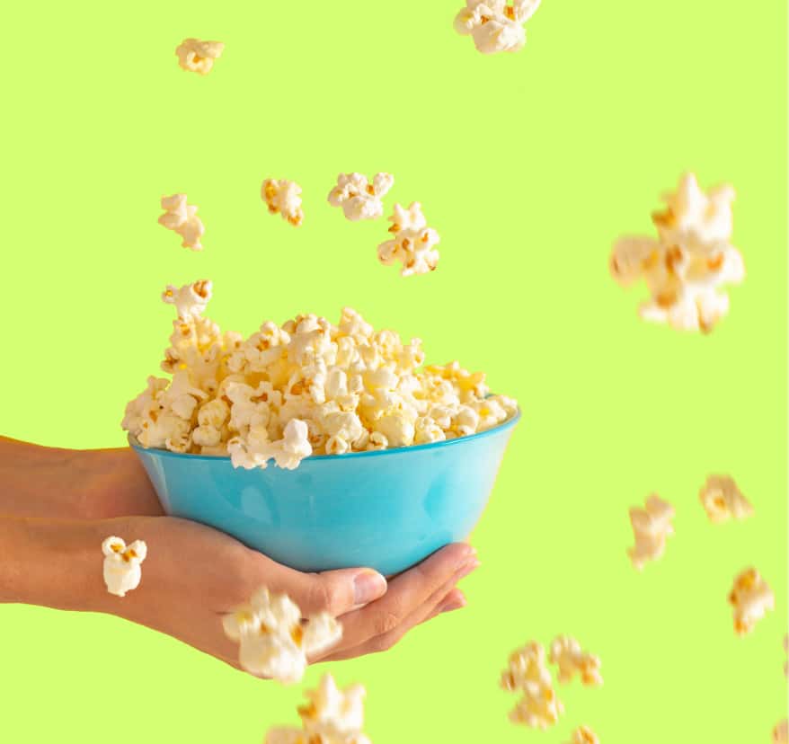 Hands holding popcorn 