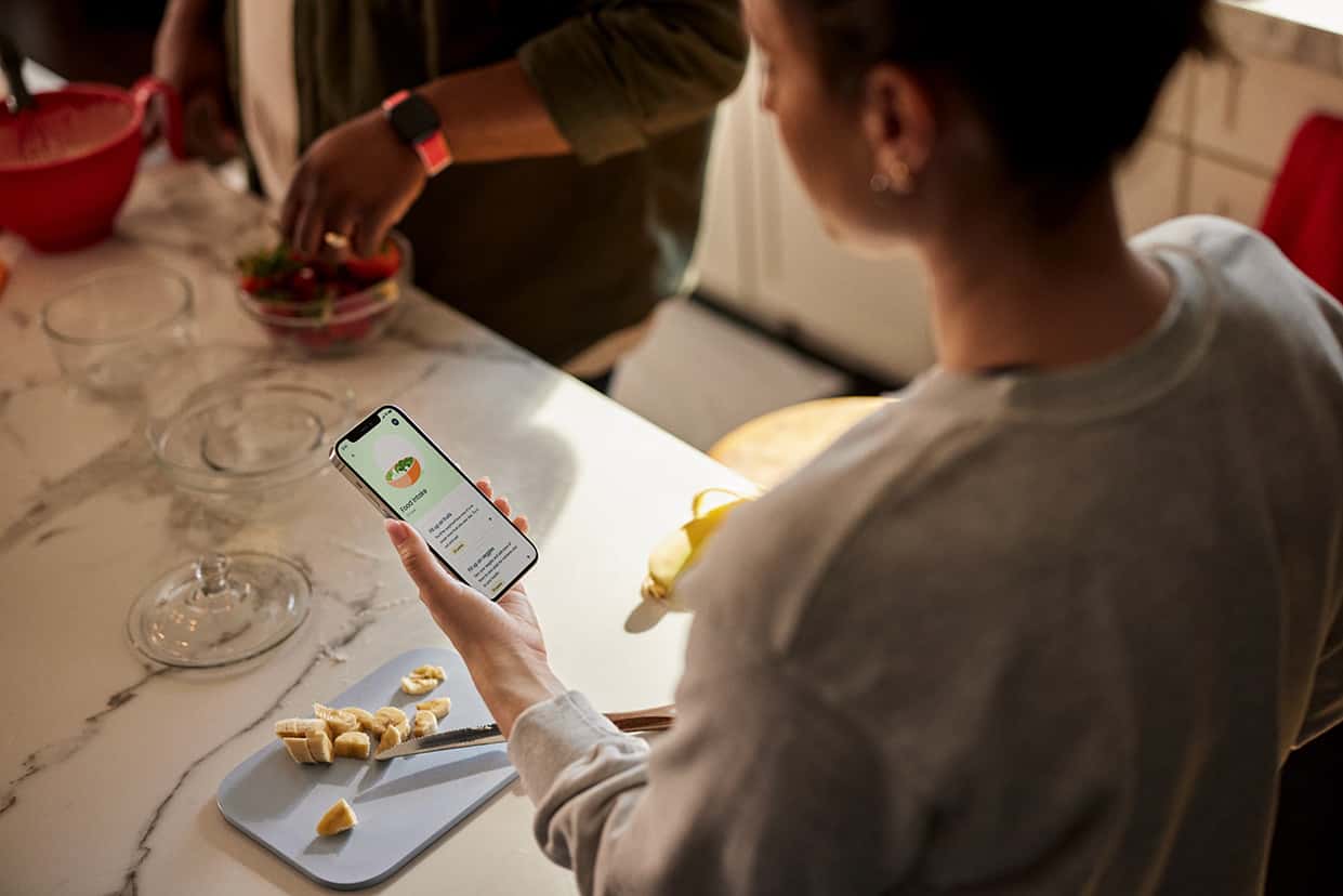 Snacking woman looking at phone