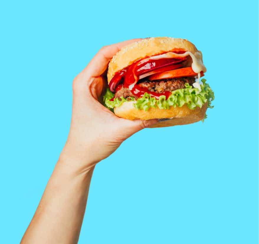 Hand holding burger