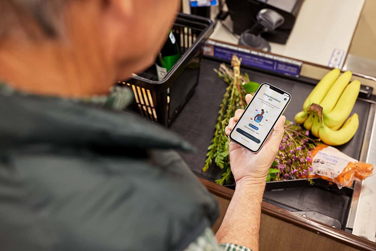 Man using app to buy healthy food at grocery store
