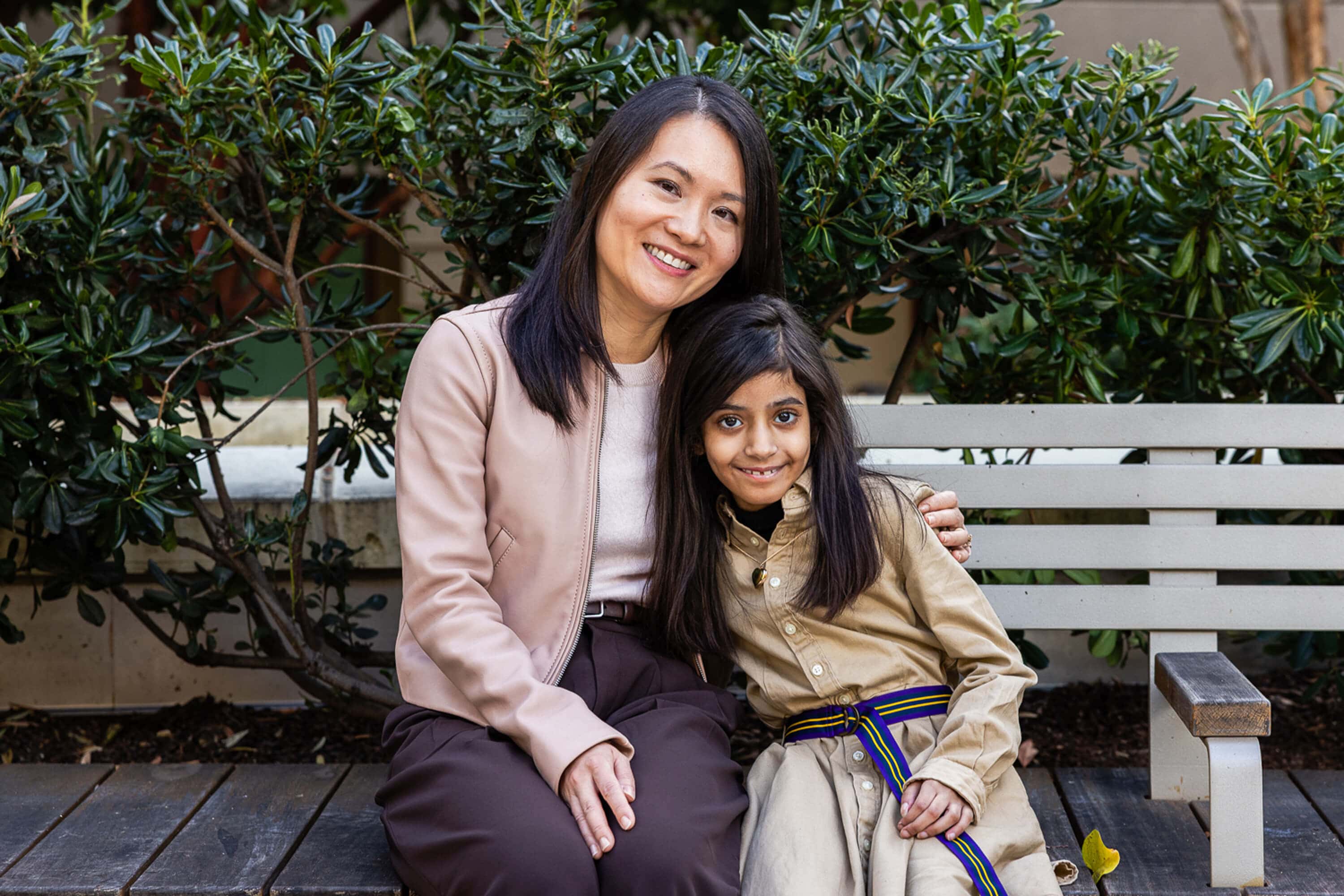 Dr. Si and Leen on a bench at Stanford Medicine Children's Health