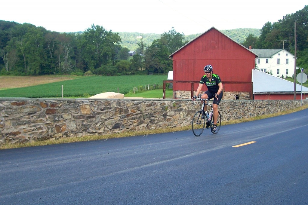 Cyclist by Barn
