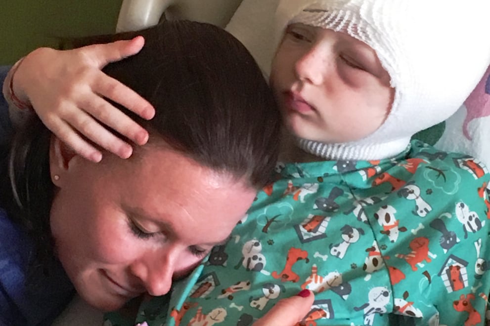Molly, recovering after surgery at Stanford Children’s Health, with her mother, Bridget Britt. 