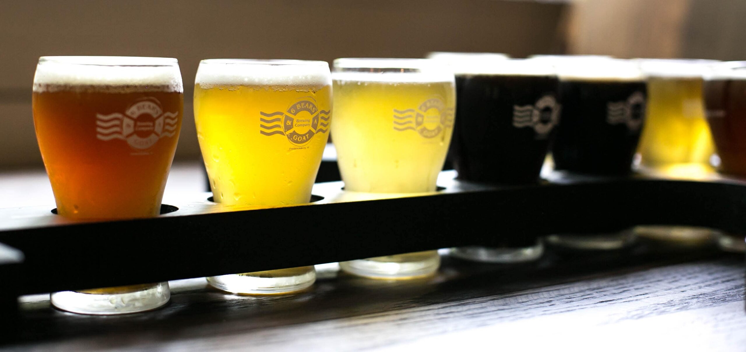 A flight of 6 Bears & a Goat Brewing Company beers including Poler Roller IPA, Trop Hours, Mae West, and O'Dark Thirty. (Photo credit: Tiffany Josephs)