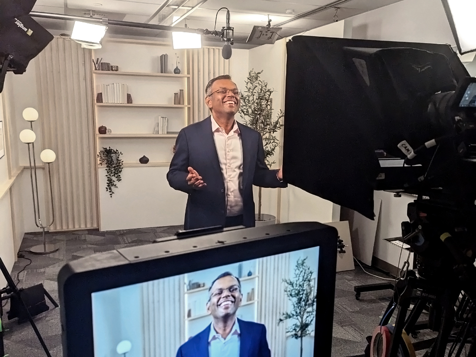 A man standing in front of a camera in a studio.