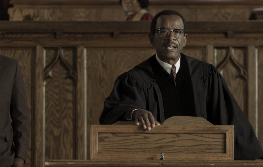 Two men standing in front of a pulpit in a church.