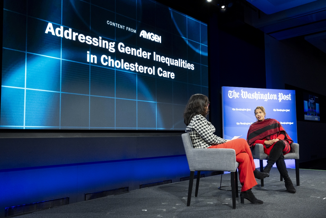 Two women on stage talking about addressing gender inequities in chesterton care.