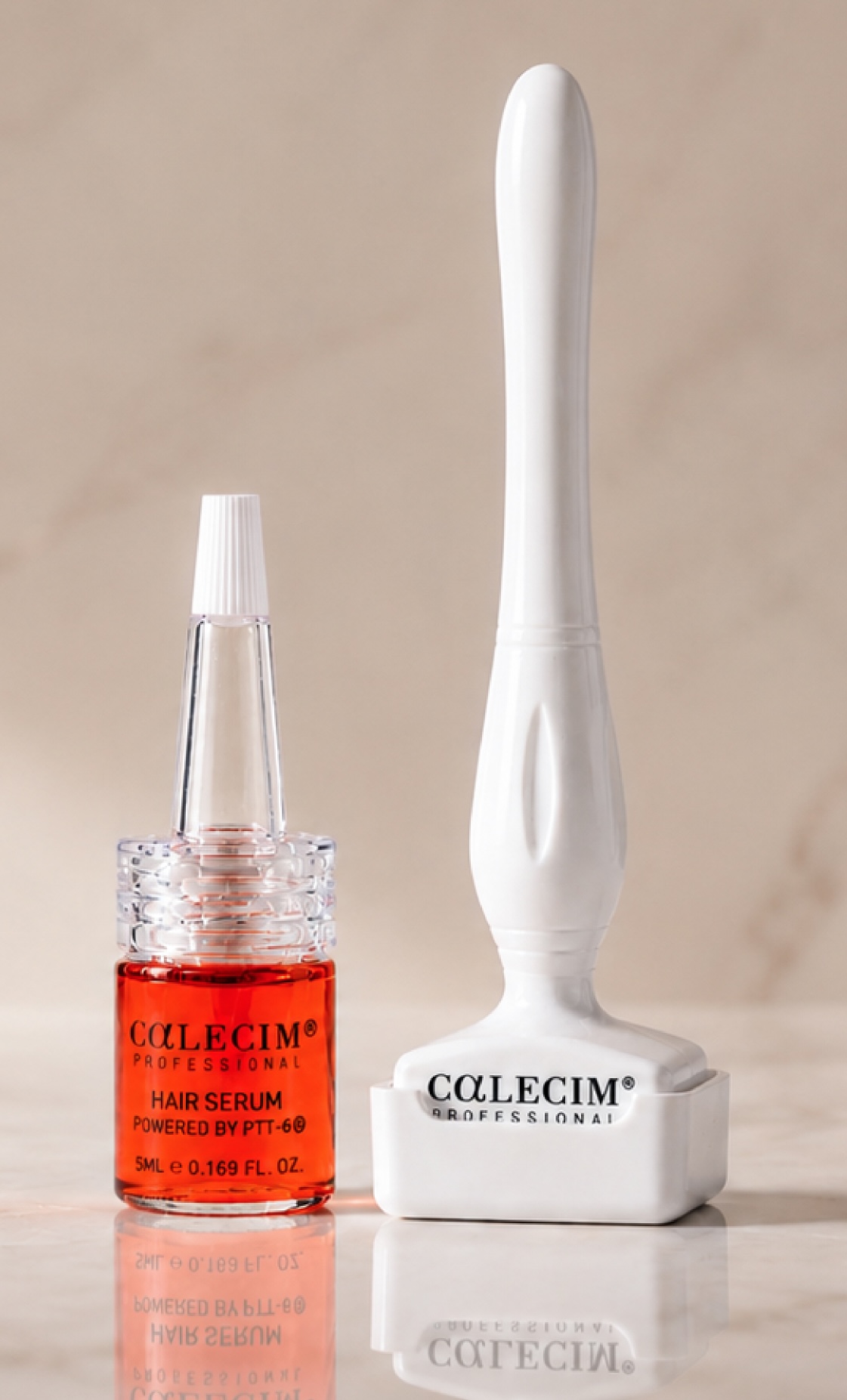 A CALECIM Professional hair serum bottle with orange liquid next to a white derma stamp tool, both on a light marble surface.